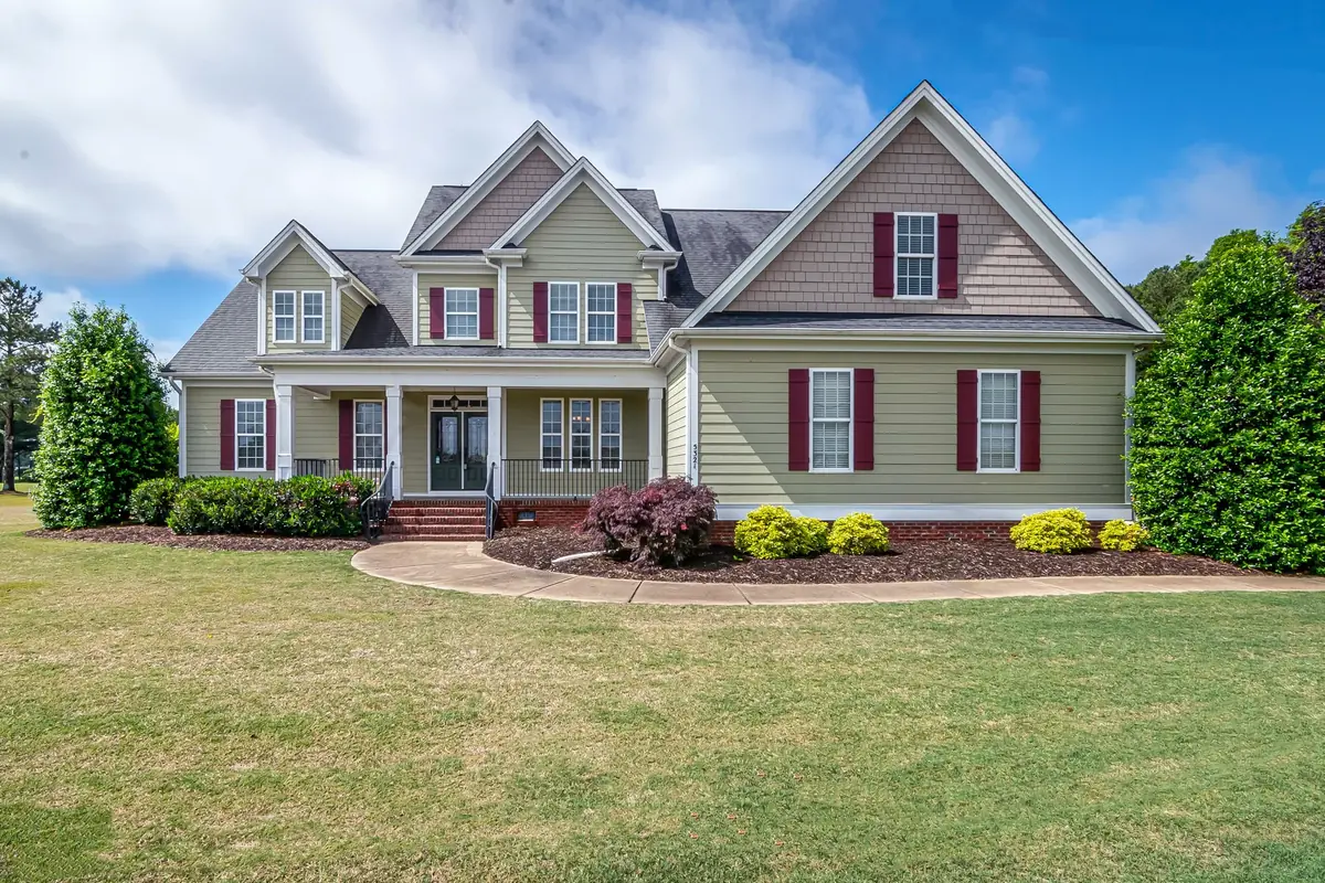 Two-story home with a front porch and manicured lawn
